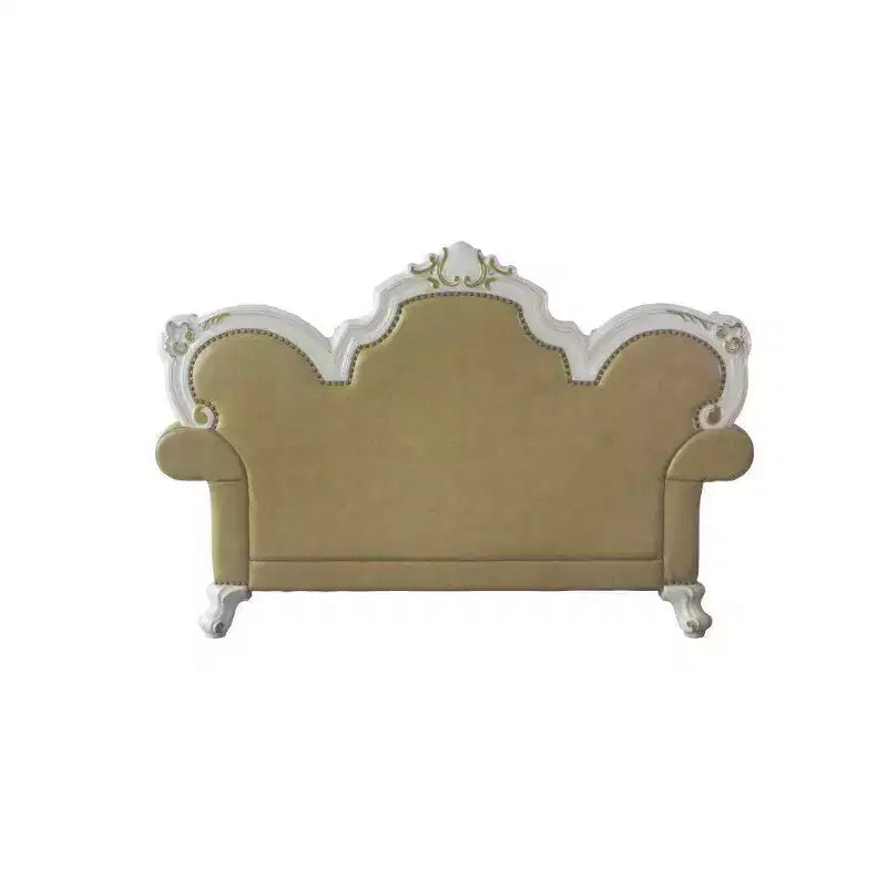 Divanetto capitonné con cornice intagliata e cuscini decorativi
