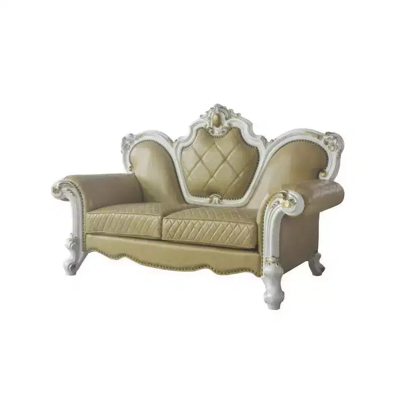 Divanetto capitonné con cornice intagliata e cuscini decorativi
